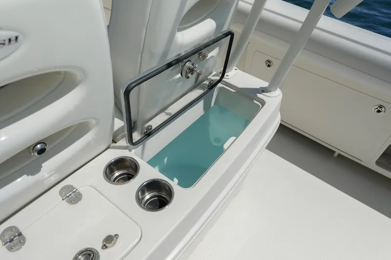  Yacht Photos Pics 2015 Sailfish 320 CC boat interior with open storage compartment and cup holders.