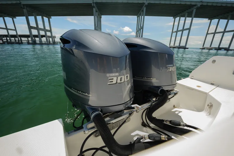  Yacht Photos Pics Twin Yamaha 300 outboard engines on a 2015 Sailfish 320 CC boat under a bridge.