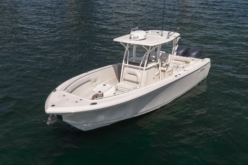  Yacht Photos Pics 2015 Sailfish 320 CC boat on water, featuring sleek design and dual engines.