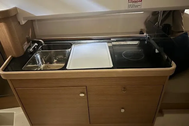  Yacht Photos Pics Compact kitchen area in a 2023 Nimbus C11 boat with sink and stove.