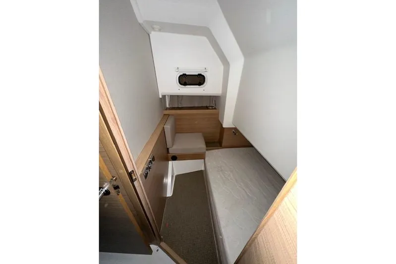  Yacht Photos Pics 2023 Nimbus C11 cabin interior with modern wood finish and compact design.