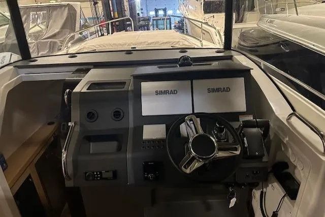  Yacht Photos Pics Cockpit of 2023 Nimbus C11 boat with dual Simrad displays and steering wheel.