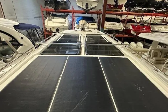  Yacht Photos Pics 2023 Nimbus C11 boat with solar panels, stored indoors among other boats.