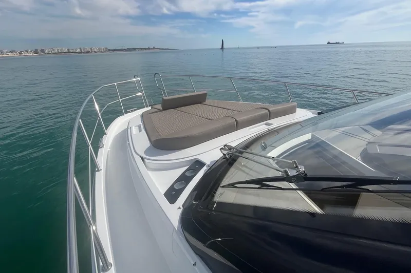  Yacht Photos Pics 2026 Galeon 400 Fly yacht with sunbathing area, cruising on calm sea.