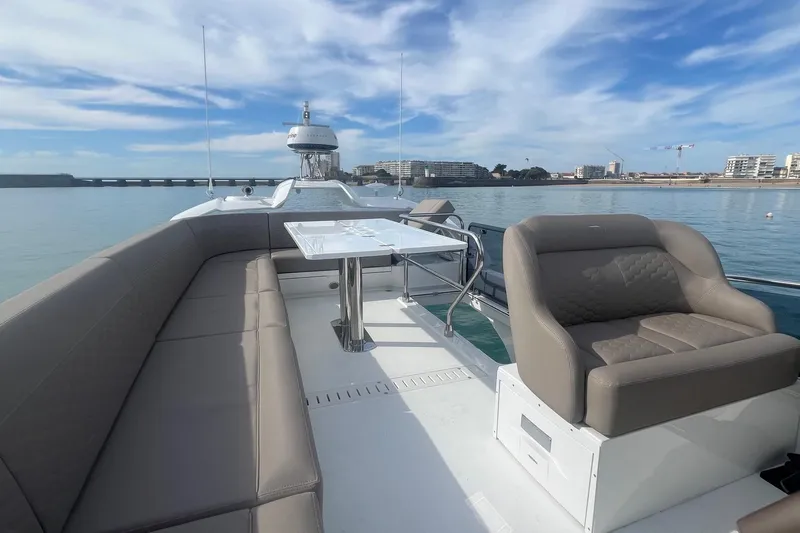  Yacht Photos Pics 2026 Galeon 400 Fly yacht deck with seating and table, overlooking calm waters.