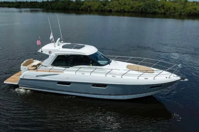  Yacht Photos Pics 2015 Cruisers Cantius yacht on calm water, featuring sleek design and spacious deck.
