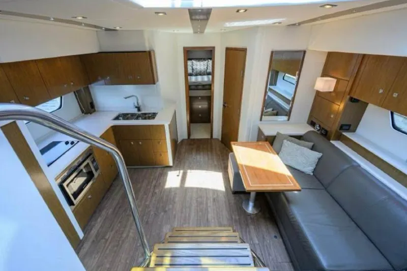  Yacht Photos Pics 2015 Cruisers Cantius yacht interior with modern kitchen, dining area, and comfortable seating.