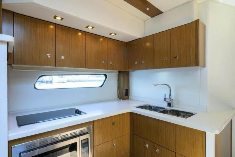  Yacht Photos Pics 2015 Cruisers Cantius yacht kitchen with modern wood cabinets and sleek appliances.