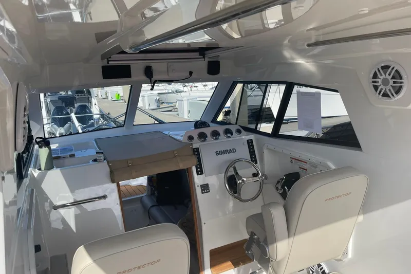  Yacht Photos Pics Interior of 2024 Protector 330 Targa boat with modern controls and seating.