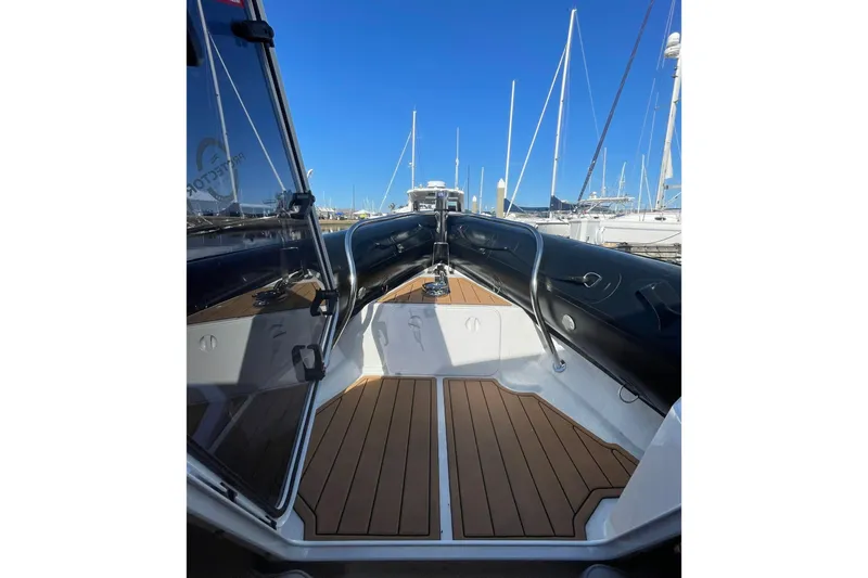  Yacht Photos Pics 2024 Protector 330 Targa boat interior with teak flooring and sleek design.