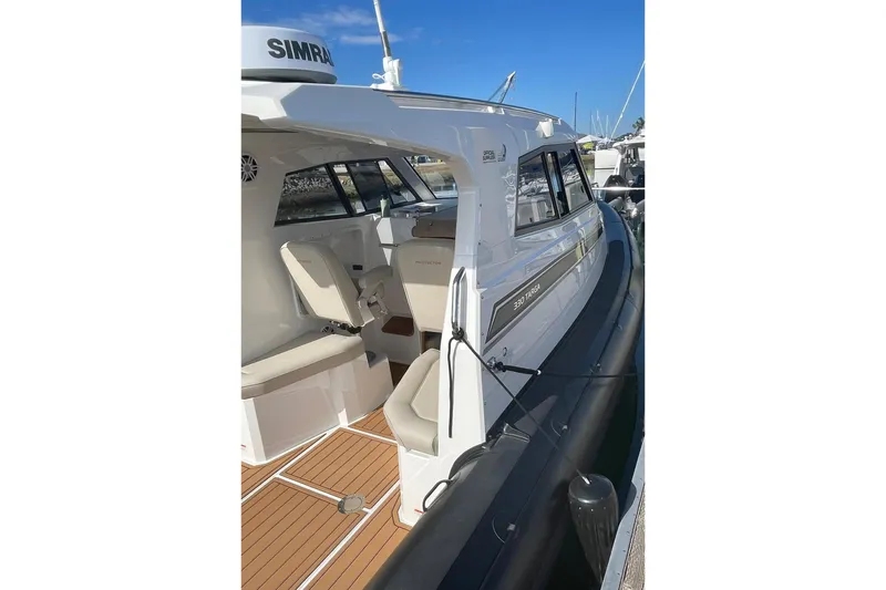  Yacht Photos Pics 2024 Protector 330 Targa boat with twin 400 HP engines, docked, featuring sleek design.