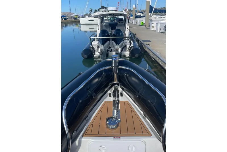  Yacht Photos Pics 2024 Protector 330 Targa boat with twin 400 HP engines docked at marina.