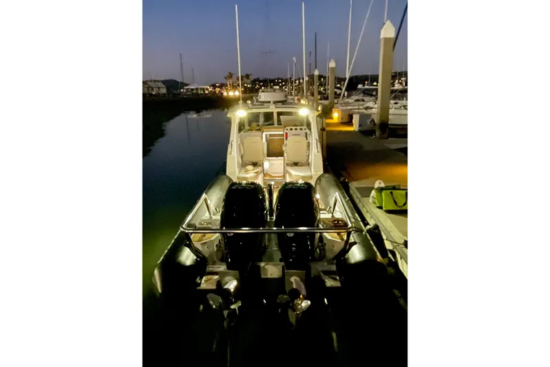  Yacht Photos Pics 2024 Protector 330 Targa boat with twin 400 HP engines docked at night.