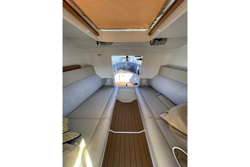  Yacht Photos Pics 2024 Protector 330 Targa cabin interior with seating and wood flooring.