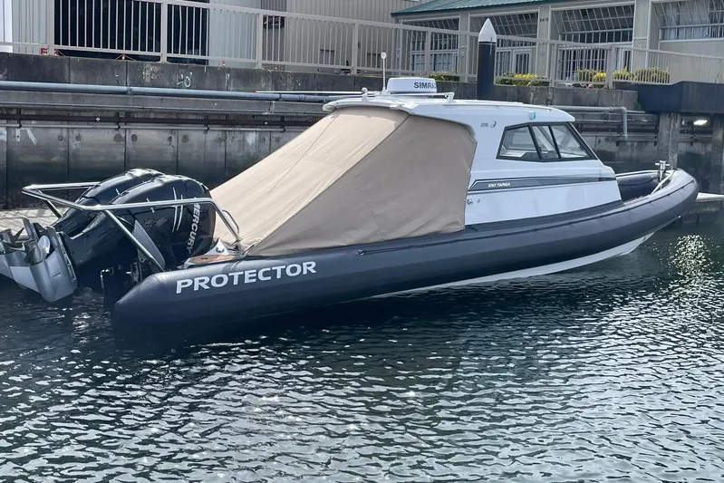 Yacht Photos Pics 2024 Protector 330 Targa boat with twin 400 HP engines docked in marina.