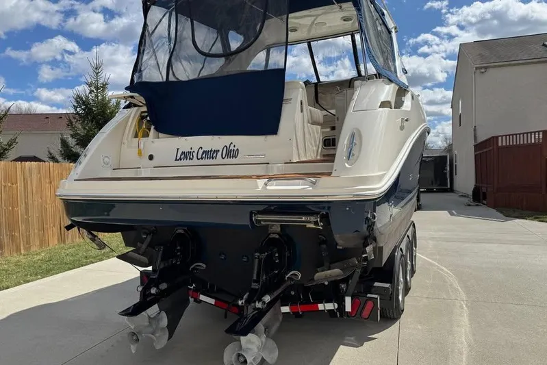  Yacht Photos Pics 2011 Sea Ray 310 Sundancer boat parked in driveway under blue sky.