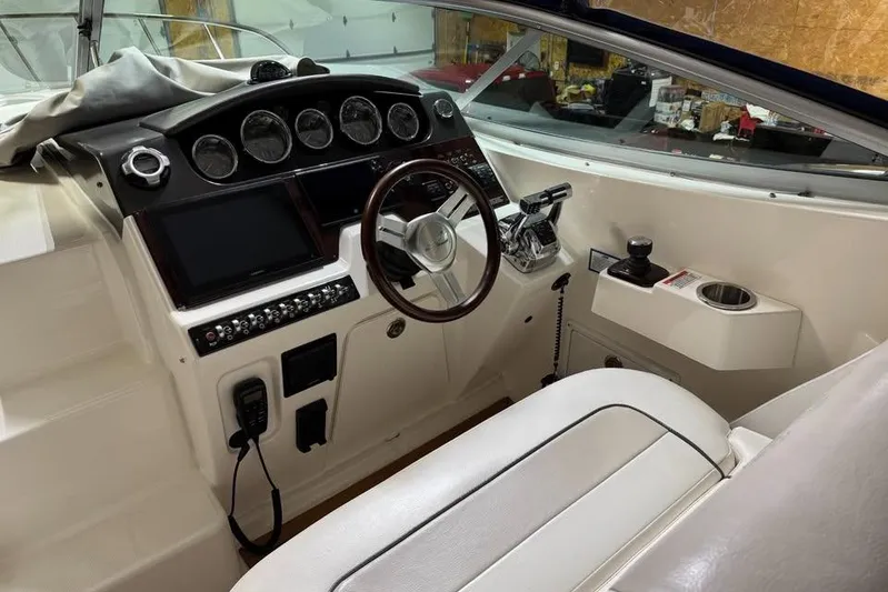  Yacht Photos Pics 2011 Sea Ray 310 Sundancer helm with steering wheel and control panel.