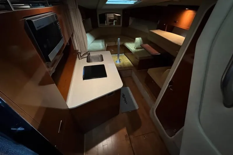  Yacht Photos Pics 2011 Sea Ray 310 Sundancer interior with kitchenette and seating area.