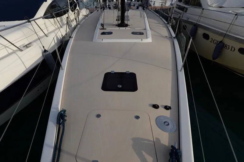  Yacht Photos Pics Deck view of a 2019 Solaris 50 yacht, docked between other boats.