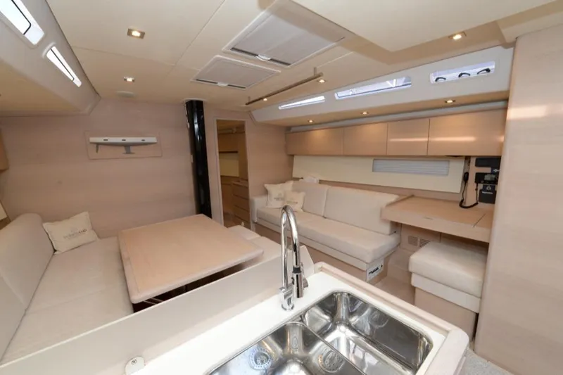  Yacht Photos Pics Luxurious interior of 2019 Solaris 50 yacht with modern seating and kitchen area.