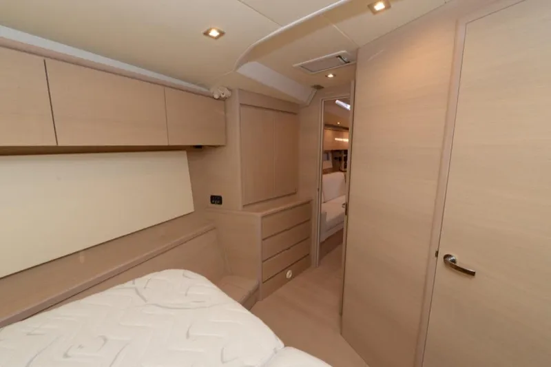  Yacht Photos Pics Luxurious interior of 2019 Solaris 50 yacht with modern wood finish and cozy bedroom.