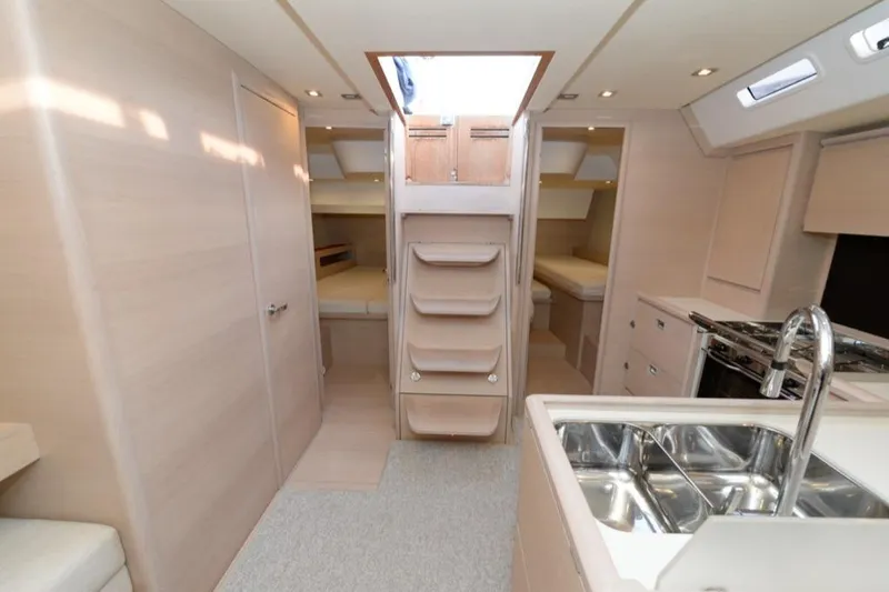  Yacht Photos Pics Interior of 2019 Solaris 50 yacht, featuring modern kitchen and cozy sleeping quarters.