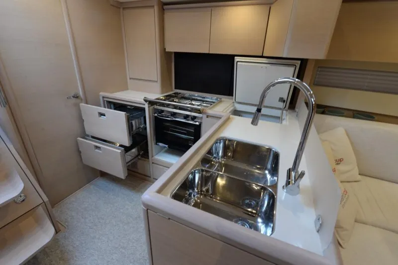  Yacht Photos Pics Modern kitchen interior of 2019 Solaris 50 yacht with dual sink and open drawers.