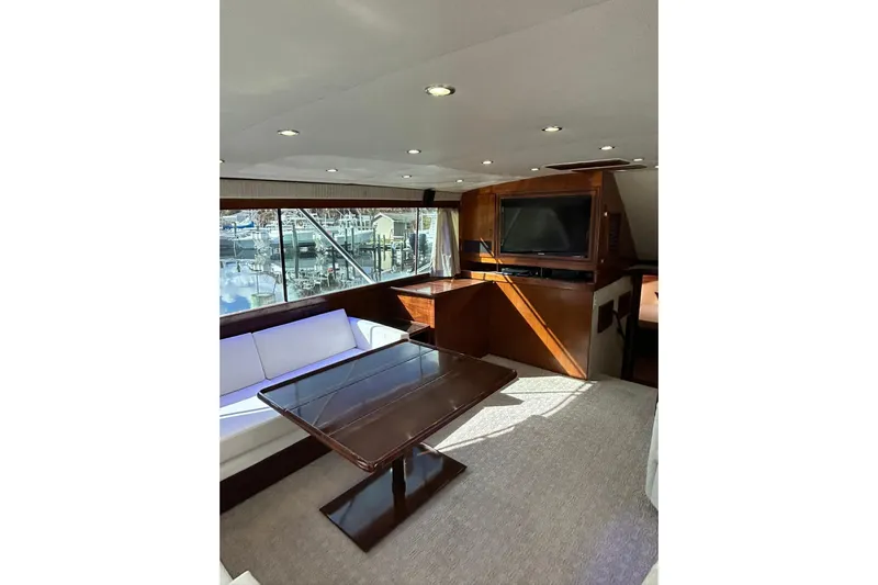 Nelmar Yacht Photos Pics Luxurious interior of 1988 Ocean Yachts 48 Super Sport with elegant seating and large windows.