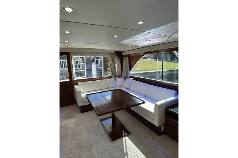 Nelmar Yacht Photos Pics Luxurious interior of 1988 Ocean Yachts 48 Super Sport with elegant seating and table.