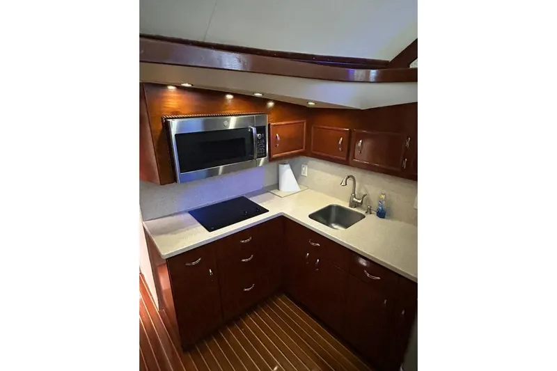 Nelmar Yacht Photos Pics Luxurious kitchen in 1988 Ocean Yachts 48 Super Sport with modern appliances and wood cabinetry.