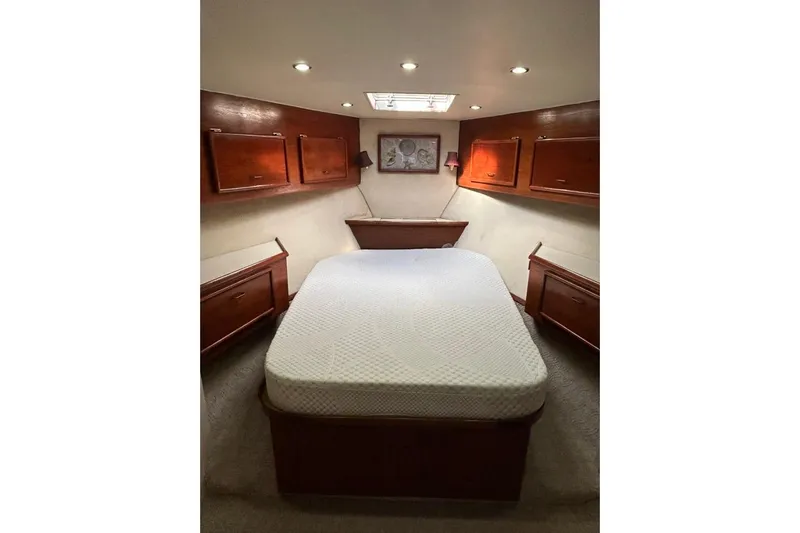 Nelmar Yacht Photos Pics Luxurious cabin interior of 1988 Ocean Yachts 48 Super Sport with cozy bed and wooden cabinets.