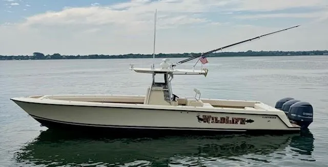 Wild Life Yacht Photos Pics 2010 Contender 39 Tournament boat on calm water with fishing gear and American flag.