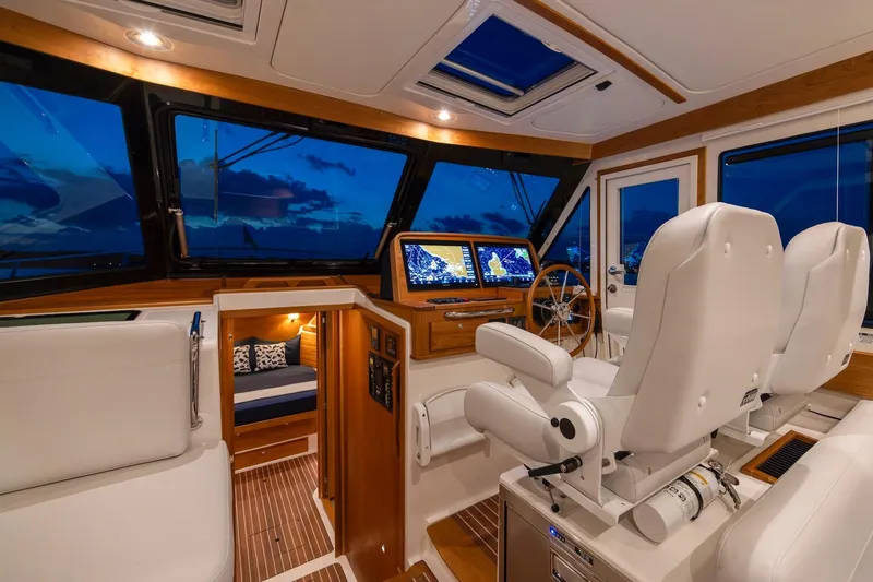 Ready For Customization Yacht Photos Pics Luxurious interior of 2027 Back Cove 412 yacht with modern navigation system and plush seating.