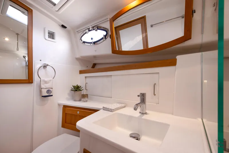 Ready For Customization Yacht Photos Pics Luxurious bathroom interior of 2027 Back Cove 412 yacht with modern fixtures and wooden accents.