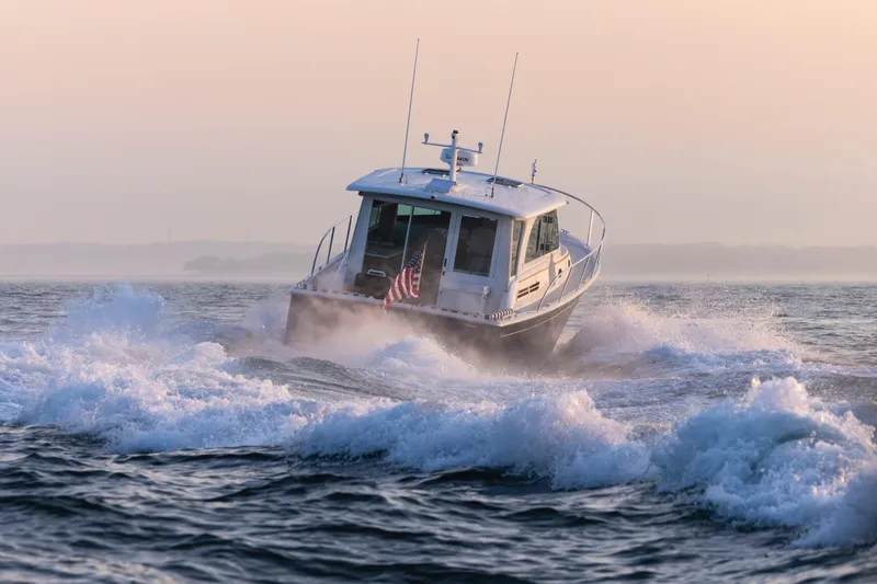 Ready For Customization Yacht Photos Pics Back Cove 412 boat cruising through waves at sunrise, 2027 model.