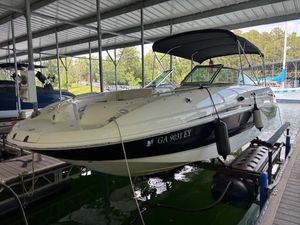 2007 Chaparral Sunesta 274 boat docked under a covered marina.
