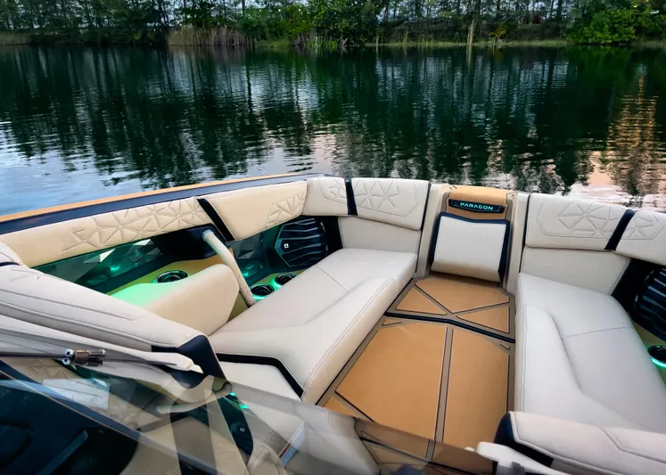  Yacht Photos Pics Luxurious interior of 2026 Nautique Paragon G25 boat with plush seating by a serene lake.