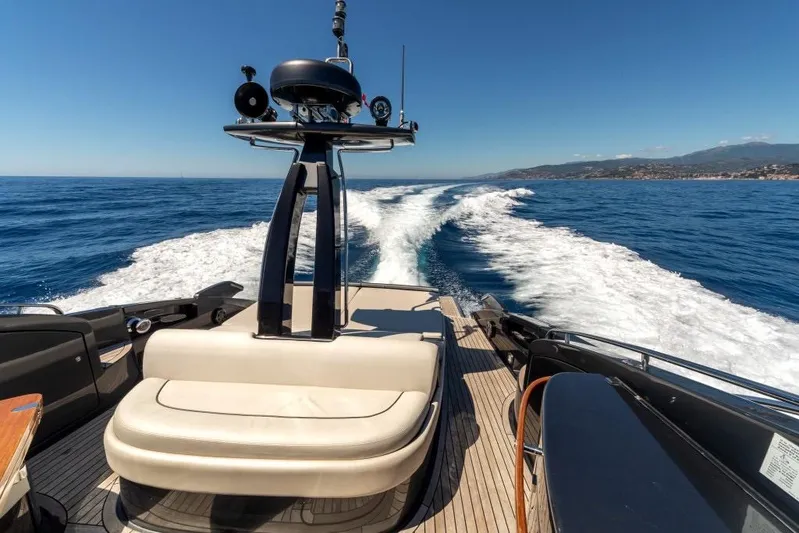  Yacht Photos Pics Luxurious 2015 Riva Rivale 52 yacht cruising on open sea with scenic coastline.
