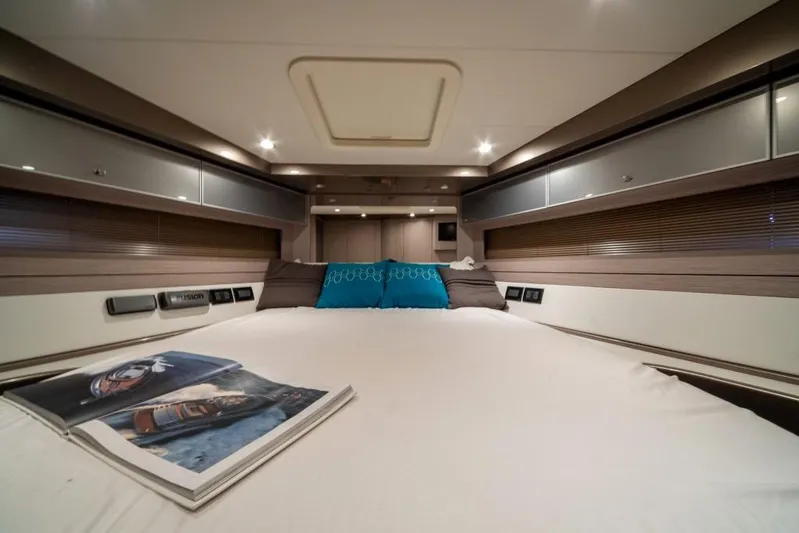  Yacht Photos Pics Luxurious cabin interior of 2015 Riva Rivale 52 yacht with cozy bed and magazine.