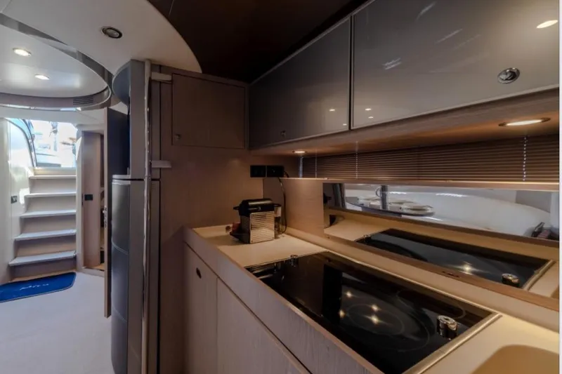  Yacht Photos Pics Luxurious interior of 2015 Riva Rivale 52 yacht, featuring modern kitchen and sleek design.