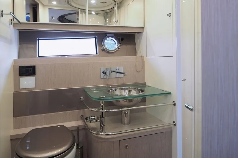  Yacht Photos Pics Luxurious bathroom interior of 2015 Riva Rivale 52 yacht with modern fixtures.