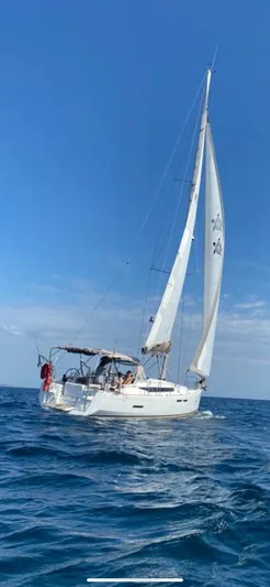 Mi Akumal Yacht Photos Pics Jeanneau Sun Odyssey 40.3 sailing on open sea under clear blue sky.