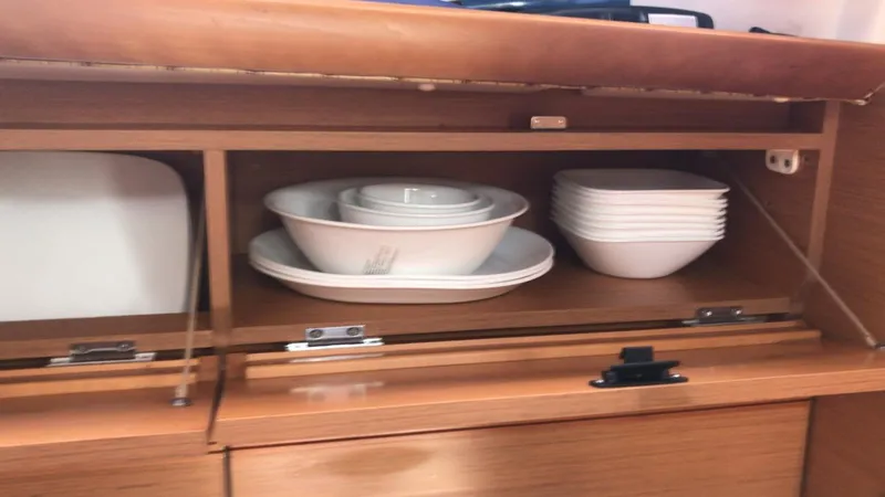 Mi Akumal Yacht Photos Pics Cabinet with white dishes and bowls on Jeanneau Sun Odyssey 40.3, 2011 model.