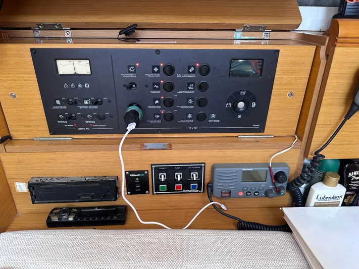 Mi Akumal Yacht Photos Pics Control panel of a 2011 Jeanneau Sun Odyssey 40.3 sailboat with various switches and devices.