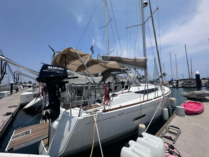 Mi Akumal Yacht Photos Pics Jeanneau Sun Odyssey 40.3 sailboat docked at marina, 2011 model, with Suzuki outboard motor.