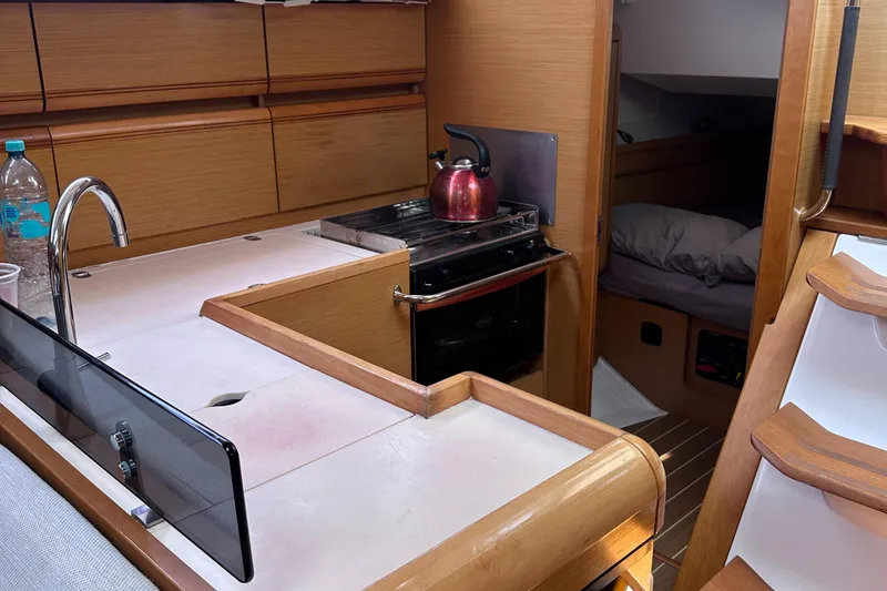 Mi Akumal Yacht Photos Pics Interior of 2011 Jeanneau Sun Odyssey 40.3 yacht, featuring kitchen and cozy cabin.