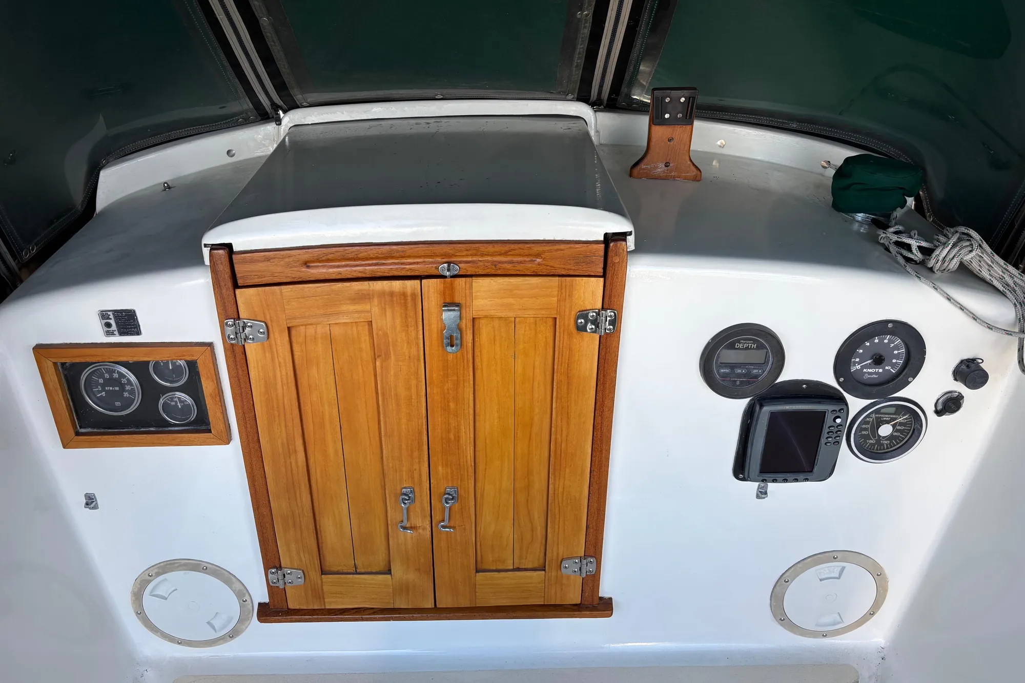 1968 Spencer 35 boat dashboard with wooden cabinet and navigation instruments.