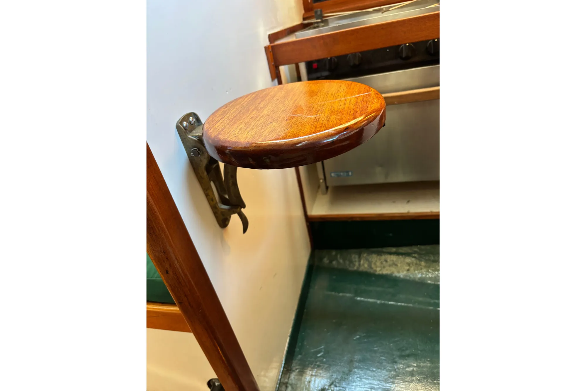 Wall-mounted wooden seat in a 1968 Spencer 35 boat interior.