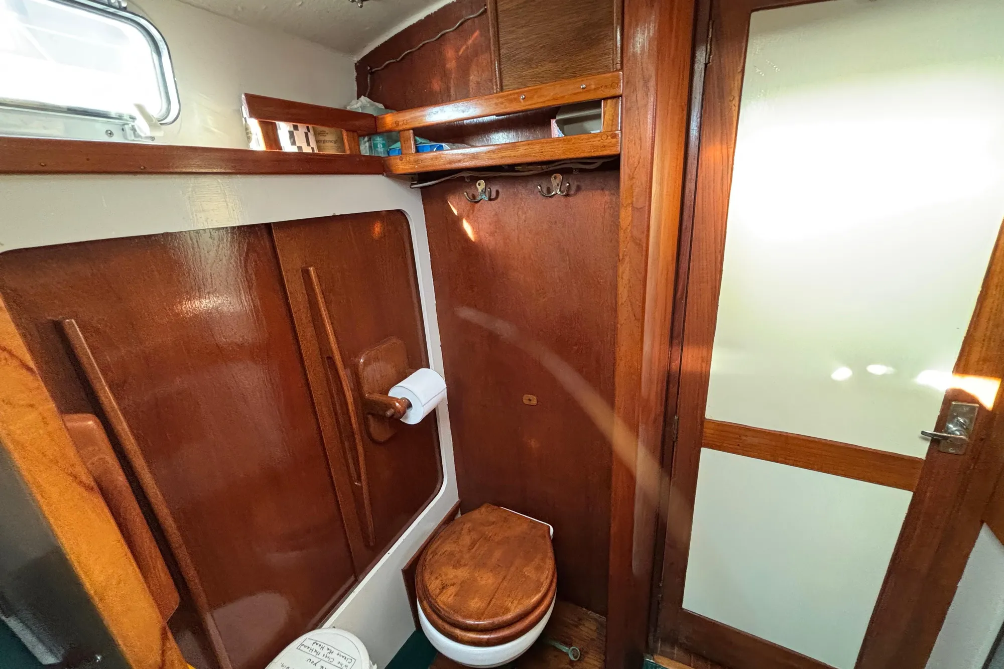 1968 Spencer 35 yacht bathroom with wooden interior and compact design.