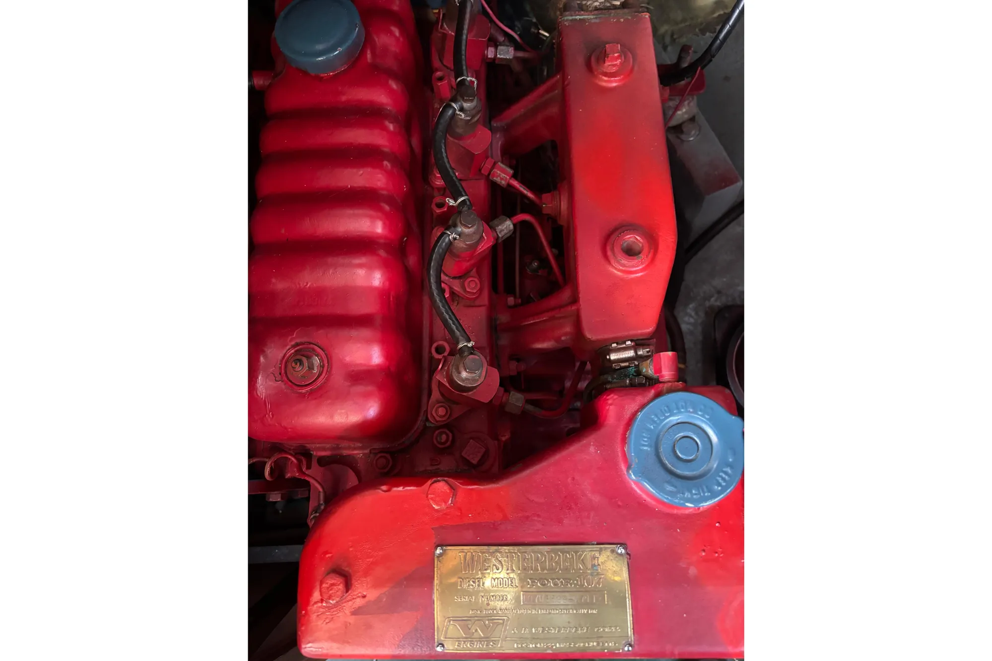 Red Spencer 35 engine from 1968 with visible components and blue cap.